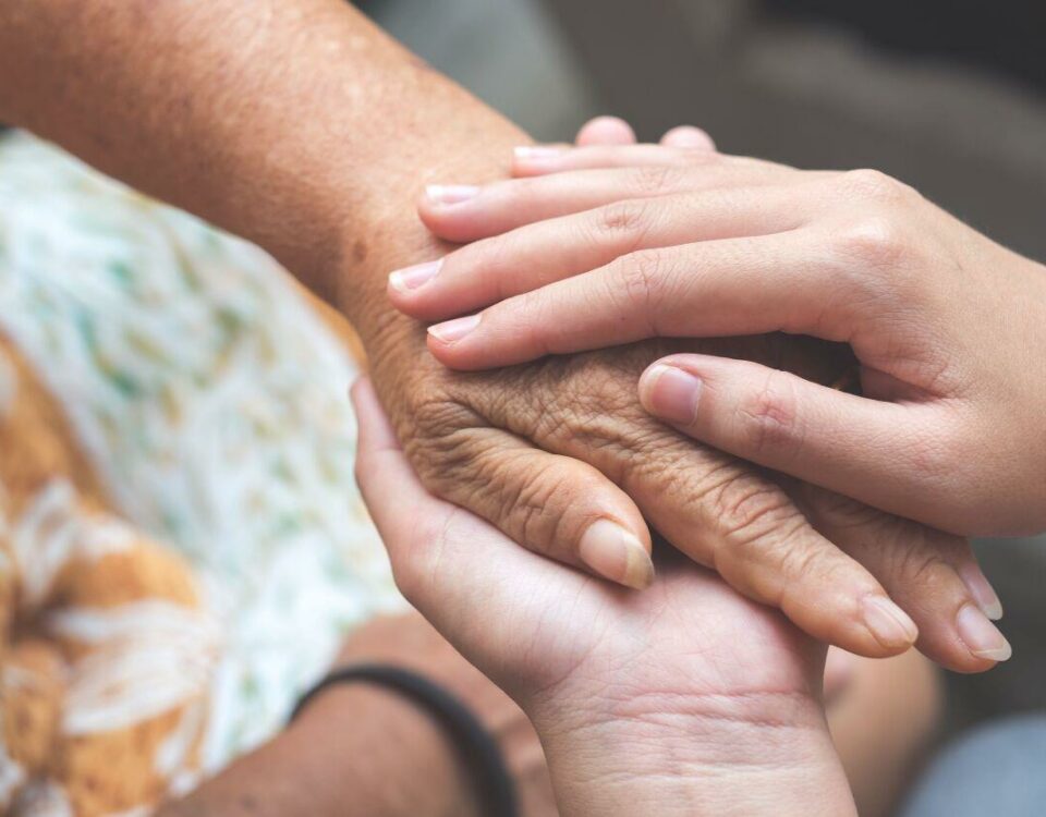 caregiver holding client's hand