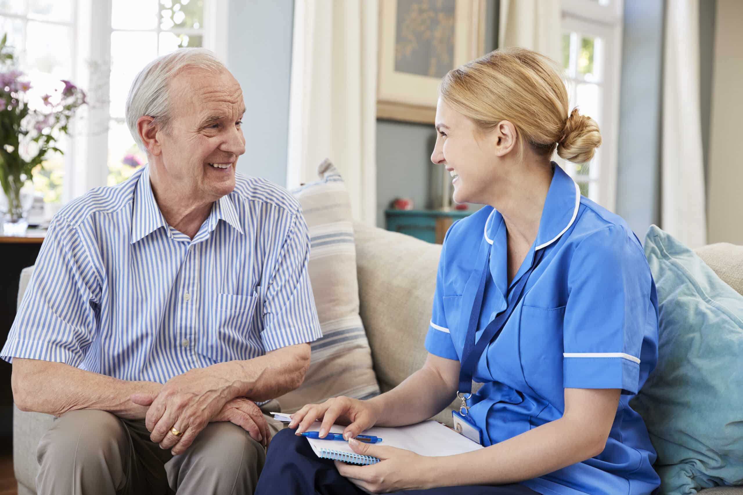 home nurse and elderly man laughing