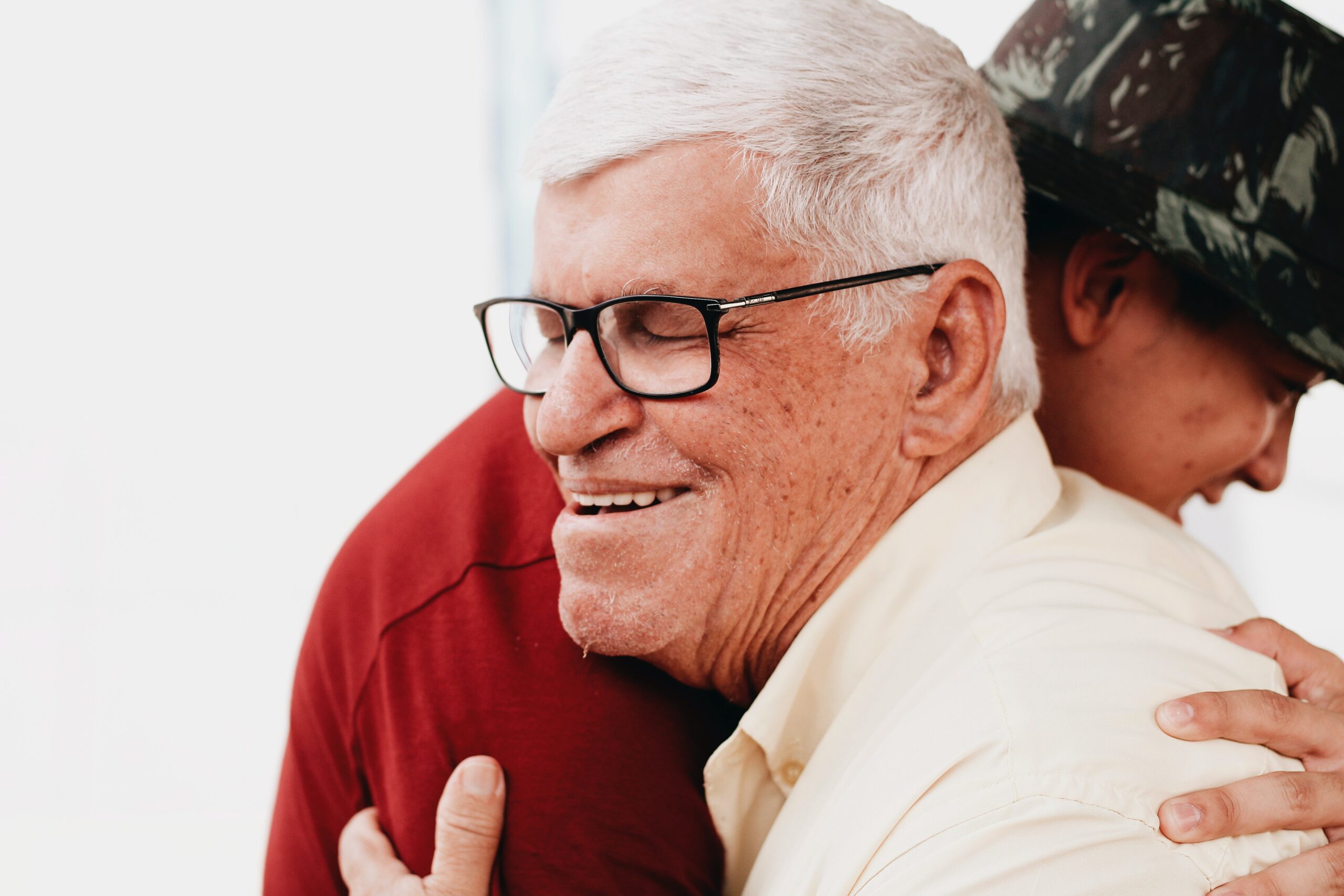 senior man hugging caregiver